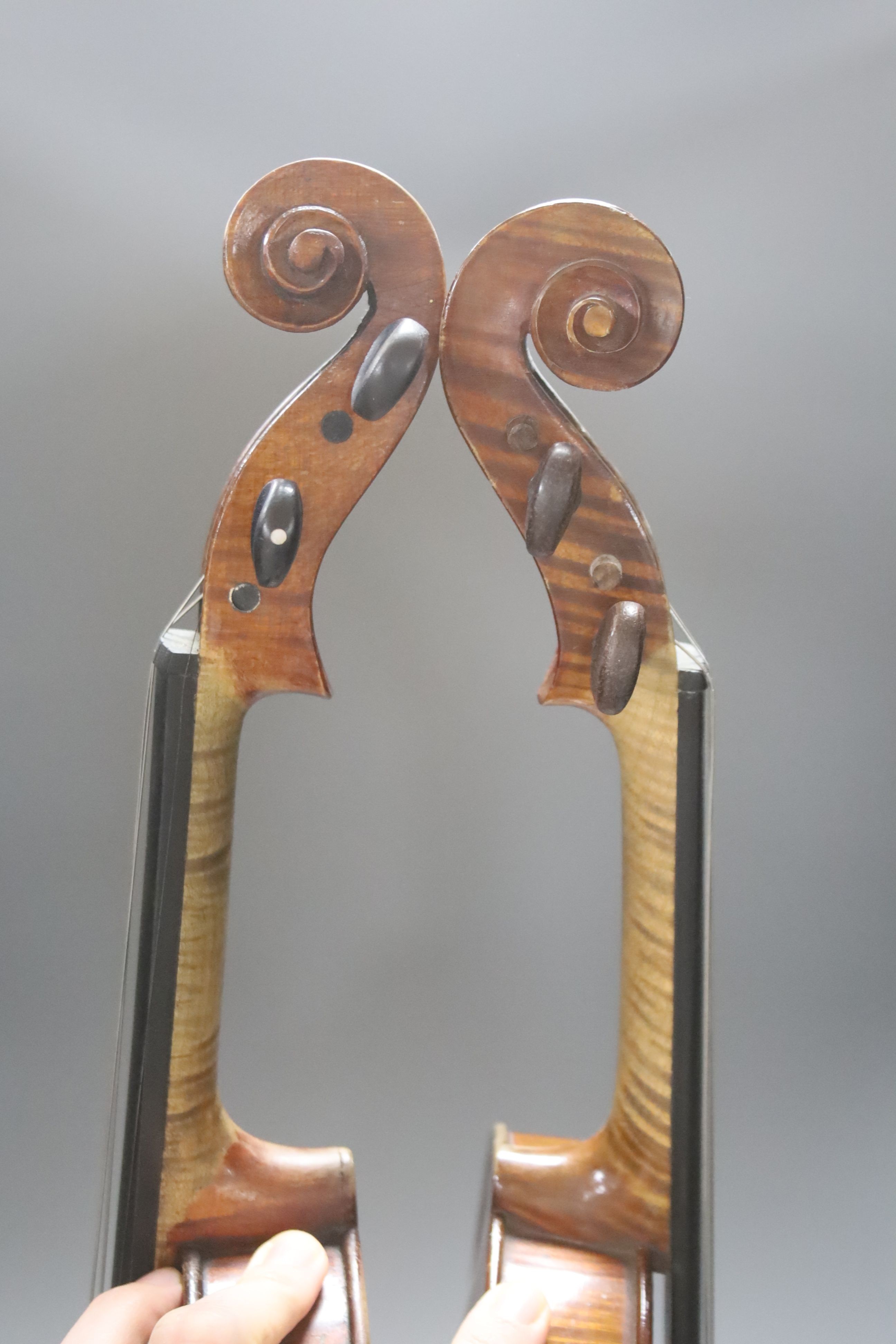 An early 20th century French vioilin, cased with bow and a cased saxon violin
